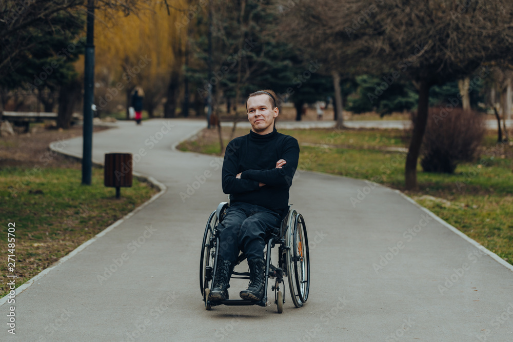 Portrait of a happy man on a wheelchair in a park Portrait of a happy man on a wheelchair in a park
