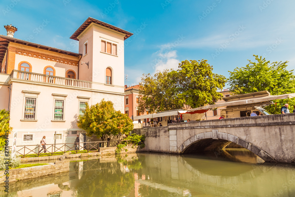 Cityscape of Portogruaro in Veneto Italy with lemene river, tower and panorama bridge