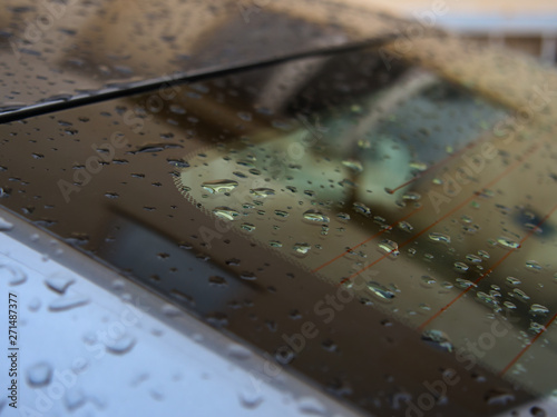 Close up of water droplets on grey car.