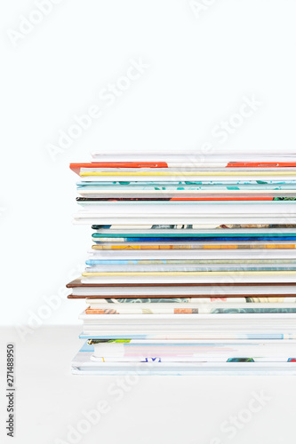 Close view of Stack of children's books on a pastel blue background.