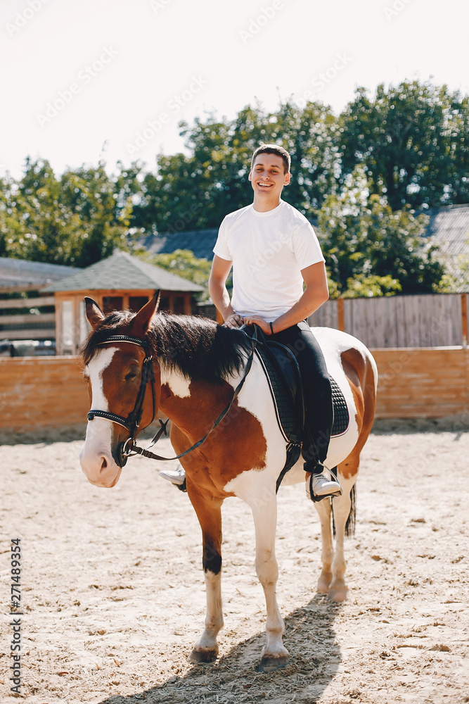Cute girl with a horse. Lady in a white t-shirt. Woman in a summer park Cute girl with a horse. Lady in a white t-shirt. Woman in a summer park