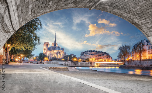 Notre Dame de Paris view from the Seine river with no people at sunset. View from under the bridge of the cathedral in Paris, France.