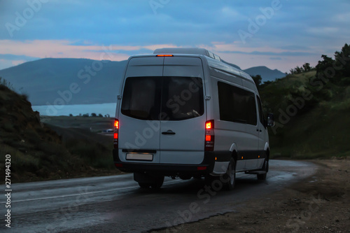 Minibus moves along the mountain winding road to the sea