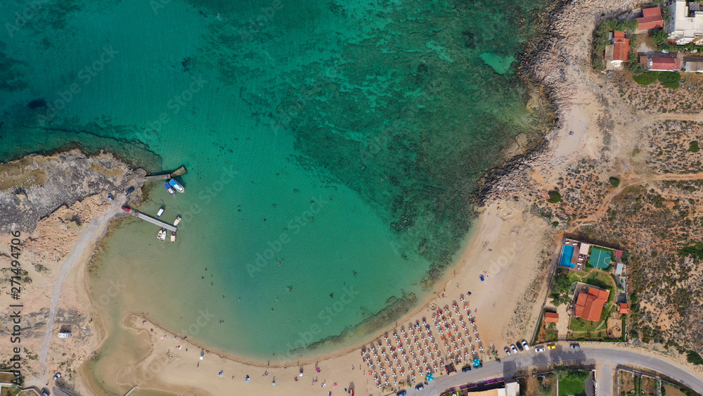 Aerial drone top view photo of turquoise organised beach forming a small heart shaped lagoon and mountainous seascape of Stavros, Chania, Crete island, Greece