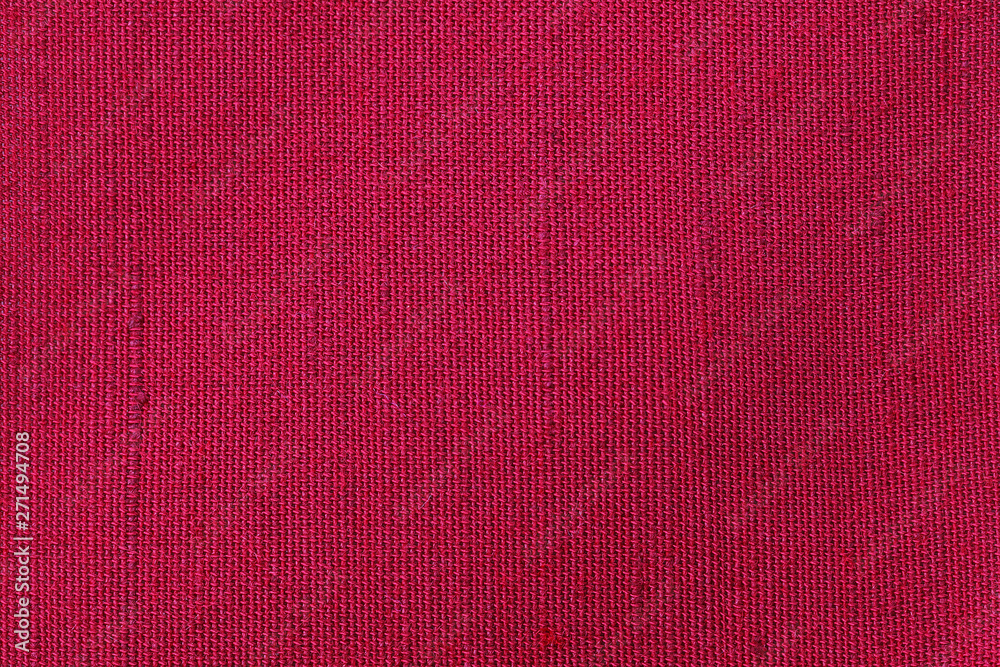 Red fabric background texture. Detail of textile material close-up
