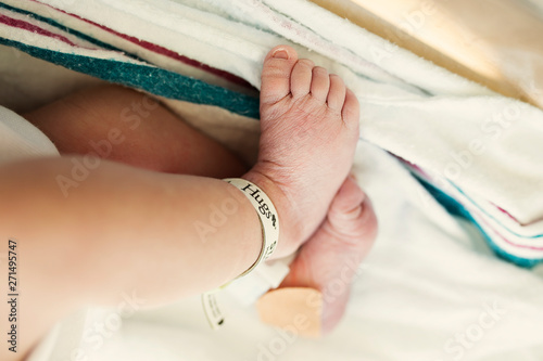 Newborn Baby Feet in Hospital Bassinet