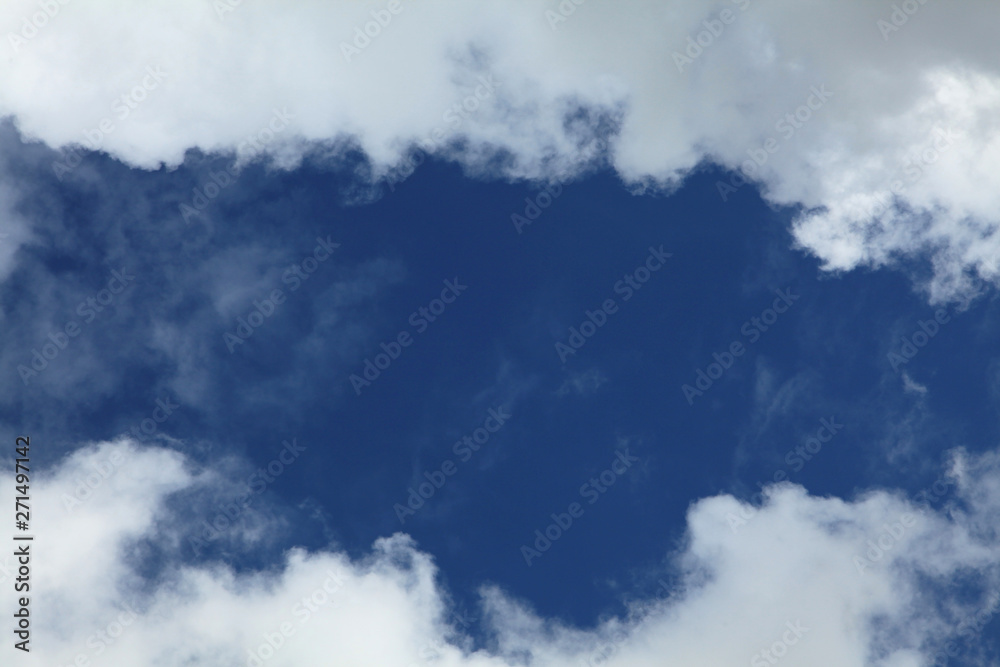 A huge cumulus and cumulonimbus clouds on the blue sky background A huge cumulus and cumulonimbus clouds on the blue sky background