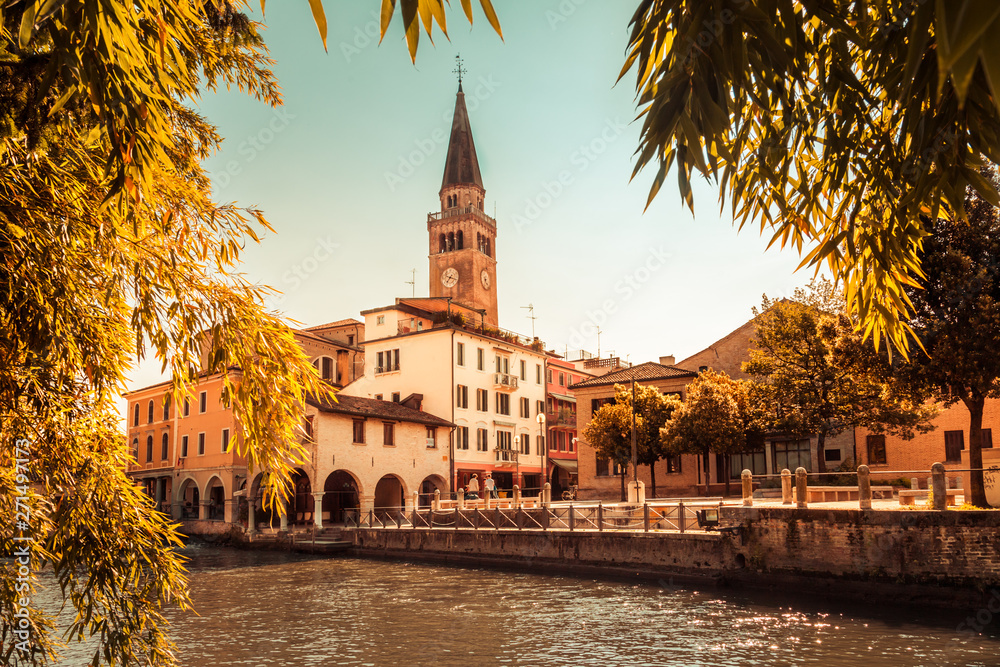 Fototapeta premium Portogruaro, Veneto Italy - May 22, 2019: Cityscape of Portogruaro with Dome Sant Andrea and Lemene river
