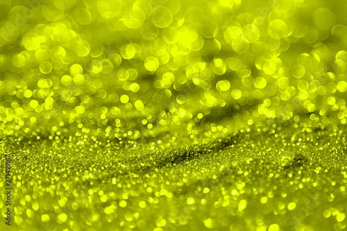 yellow shining aluminium sand made of glitters - bright concept with bokeh texture - cute abstract photo background