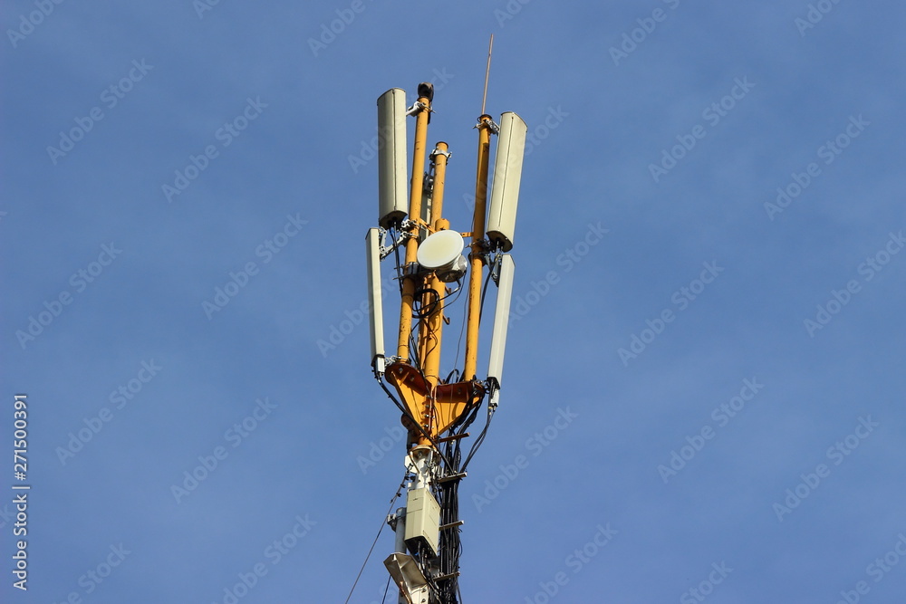 Outdoor GSM cellular phone antenna aerial close up on pole on blue sky background - telecommunication technology Outdoor GSM cellular phone antenna aerial close up on pole on blue sky background - telecommunication technology