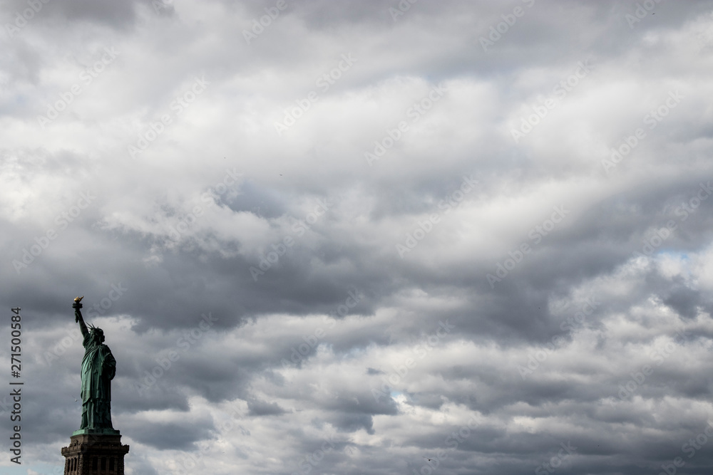 statue of liberty against cloudy sky