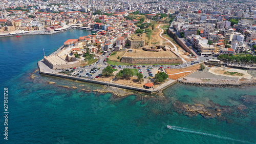 Aerial drone panoramic view of iconic and picturesque Venetian old port of Chania with famous landmark lighthouse and traditional character, Crete island, Greece