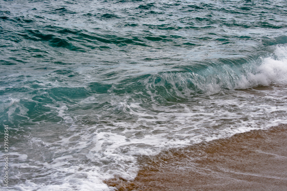 Fototapeta premium Spain, the clear water of the Mediterranean Sea, the wave rolling in the sand.