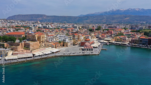 Aerial drone panoramic view of iconic and picturesque Venetian old port of Chania with famous landmark lighthouse and traditional character, Crete island, Greece