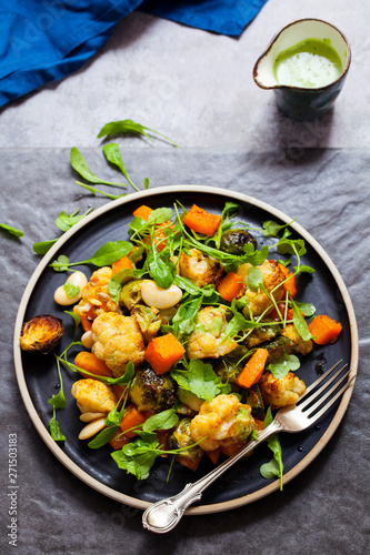 Salad of warm roasted vegetables, cauliflower, brussel sprouts, butternut squash and beans with green dressing