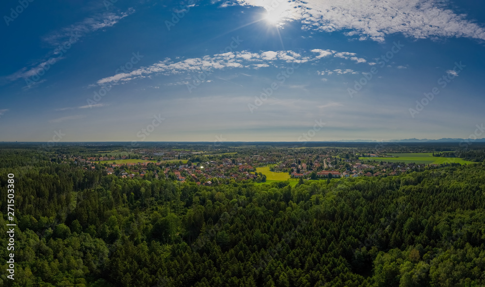 The flight over a forest at sunshine next to the bavarian Oberhaching.