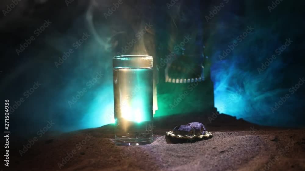 Water and dates. Iftar is the evening meal. View of decoration Ramadan Kareem holiday on sand. Festive greeting card, invitation for Muslim holiday. Selective focus Water and dates. Iftar is the evening meal. View of decoration Ramadan Kareem holiday on sand. Festive greeting card, invitation for Muslim holiday. Selective focus