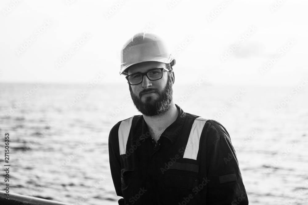 Deck Officer wearing glasses on deck of offshore vessel or ship. Work at sea.