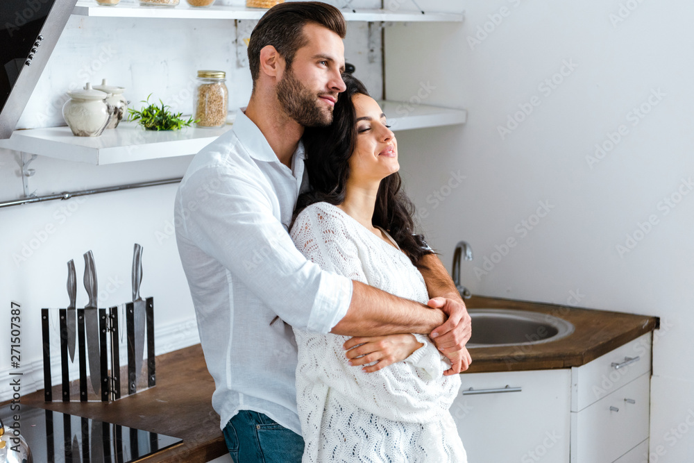 man gently embracing happy woman at home man gently embracing happy woman at home