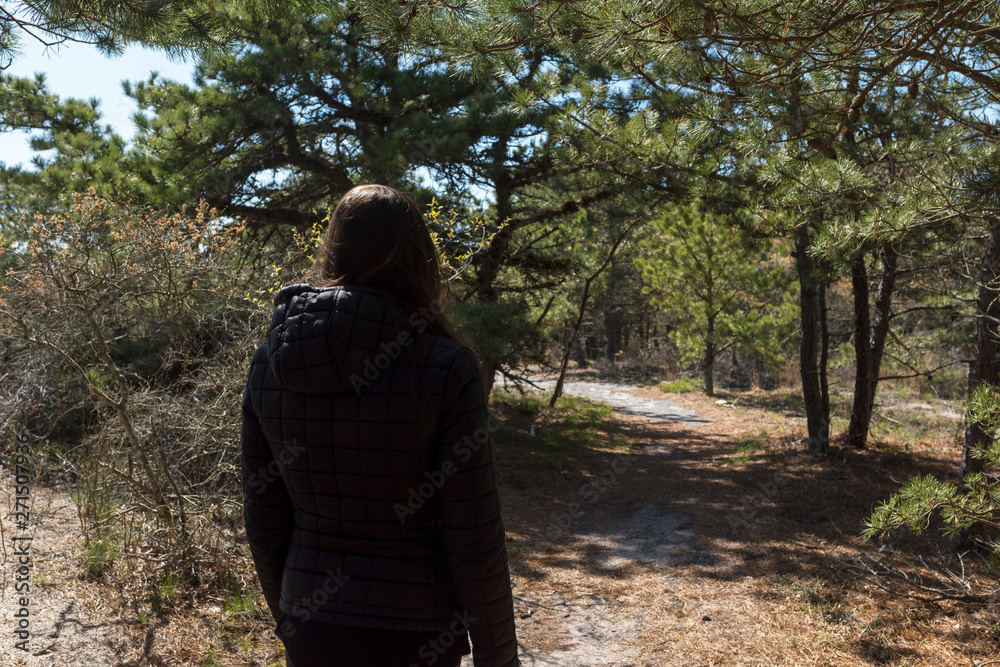 a woman looks at the trail ahead a woman looks at the trail ahead