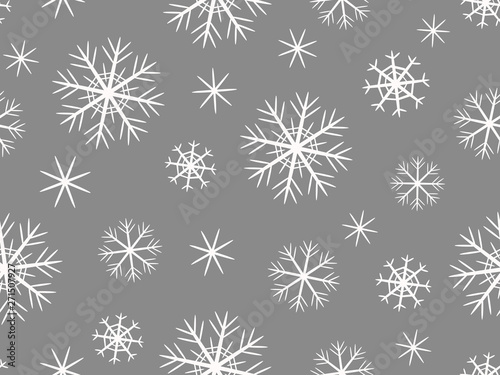 Pattern with white snowflakes of different shapes on a gray background