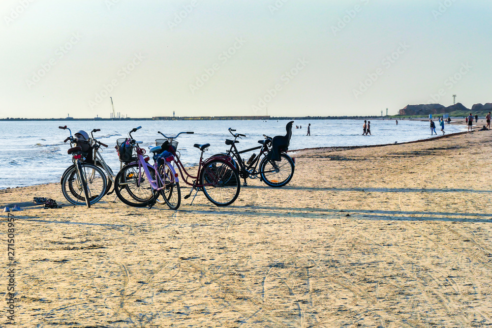 Bicycles on the beach in the summer at sunset. Leisure.