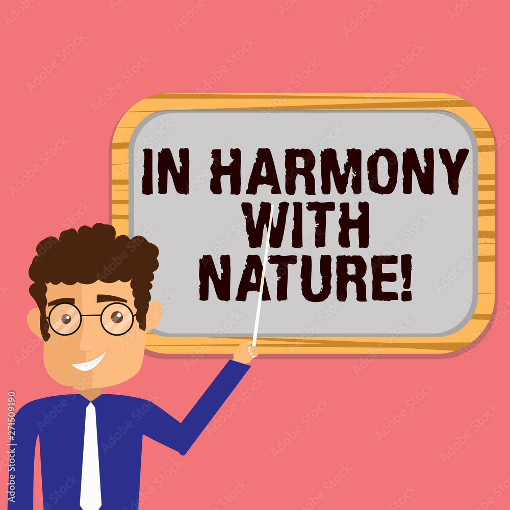 Conceptual hand writing showing In Harmony With Nature. Business photo showcasing Meditation zen peaceful attitude spirituality Man Holding Stick Pointing to Wall Mounted Blank Color Board