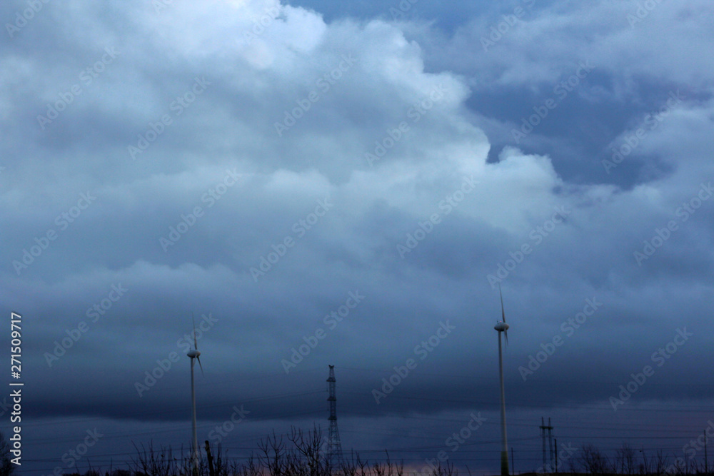 silhouettes of windmill and epic stormy sky on the background silhouettes of windmill and epic stormy sky on the background