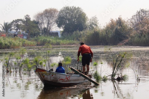 Fisherman and his son in the boat
