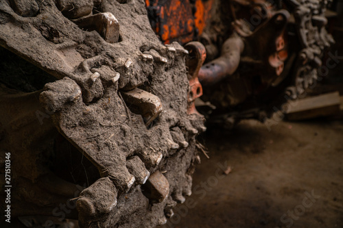 Close up of excavator tracks covered with mud