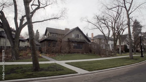 View down a street of an established neighbourhood with houses and large trees; Edmonton, Alberta, Canada