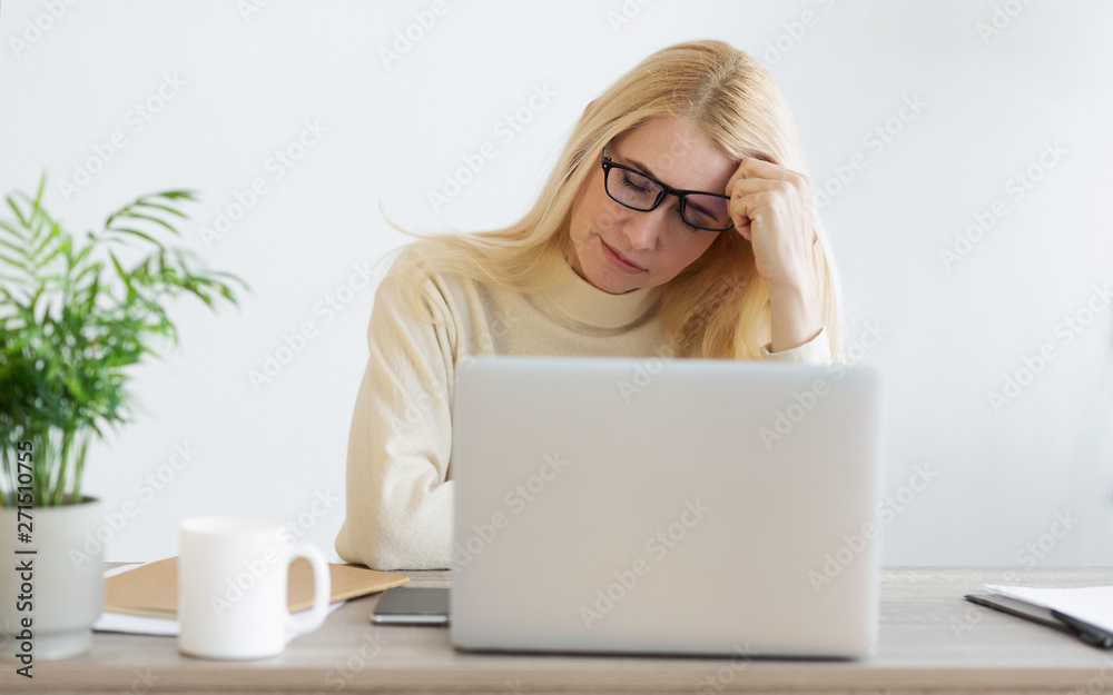 Fototapeta premium Overworked Mature Businesswoman Suffering From Headache In Office