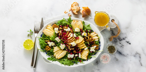 banner of Pomegranate & Pear Green Salad with Ginger Dressing on white marble . healthy breakfast or lunch