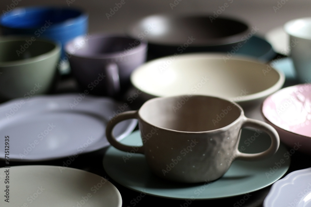 Collection of pottery and kitchenware in muted pastel colors. Selective focus. Collection of pottery and kitchenware in muted pastel colors. Selective focus.