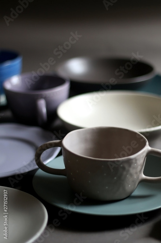 Collection of pottery and kitchenware in muted pastel colors. Selective focus.