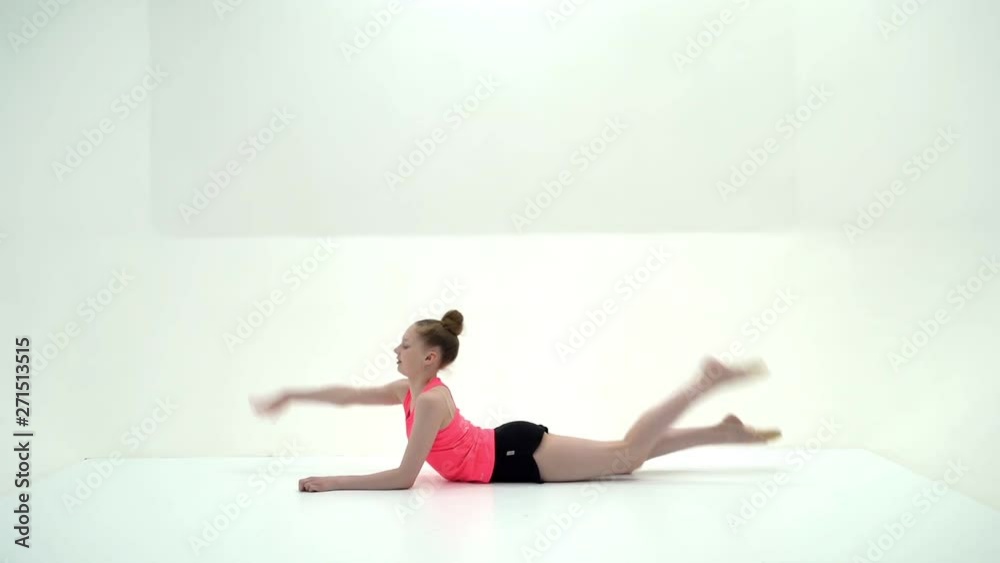 The gymnast perform an acrobatic element on the floor. The gymnast perform an acrobatic element on the floor.