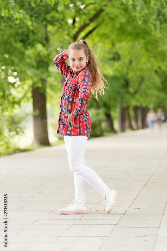Fototapeta premium Hairstyles to wear on windy days. Windproof hairstyles. Girl little cute child enjoy walk on windy day nature background. Feeling cozy and comfortable on windy day. Deal with long hair on windy day