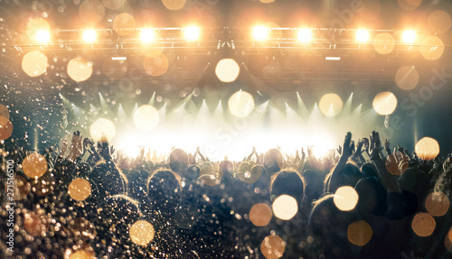 Concert spectators in front of a bright stage with live music photo