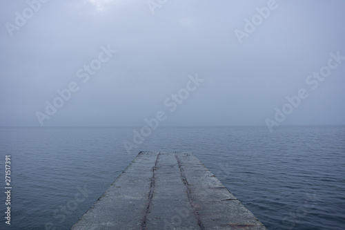 Old  empty cement piers in the dark moody sea