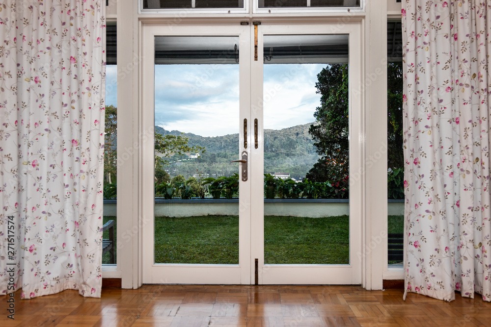 Fototapeta premium Refreshing, green, nature landscape view from home through glass door