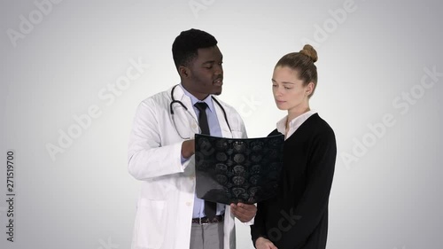 Young woman visiting radiologist for x-ray exam of her brain on gradient background. photo