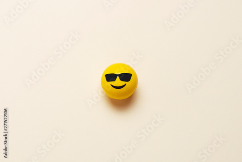 Smiling emoticon ball with sunglasses