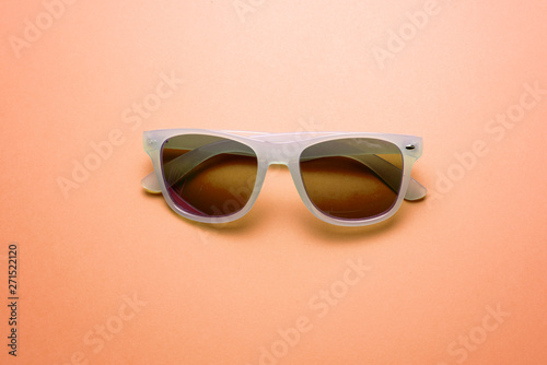 trendy style sunglasses on peach background. fashion minimal concept