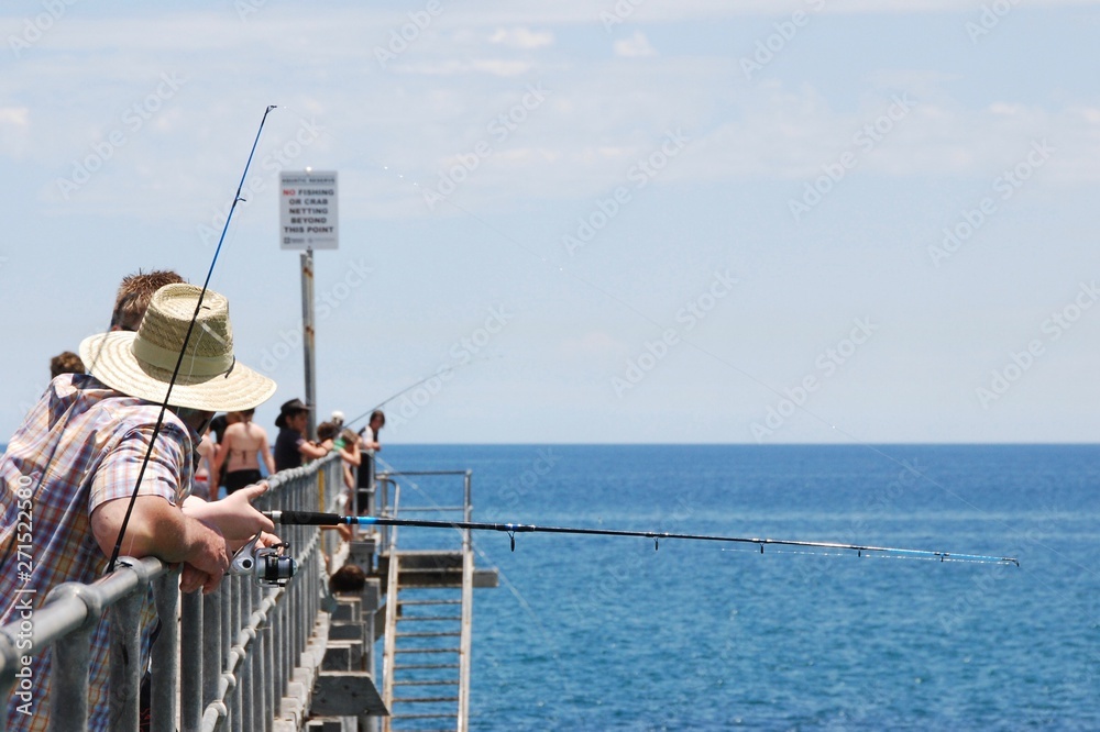 People fishing on a jetty People fishing on a jetty