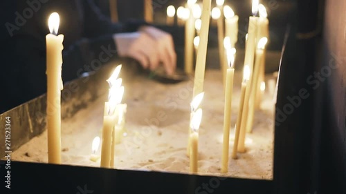 The laity in the Christian Church puts candles. Close up. Religious institution. faith in God. photo