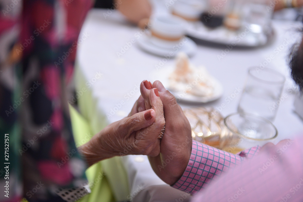 old women's hands symbolizing friendship, holding hands