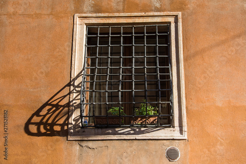 Big window with grates in venice,shadow bars,Italy,2019