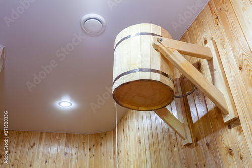 Cold water from a wooden bucket, for hardening and a healthy lifestyle.Relax in a hot sauna. photo