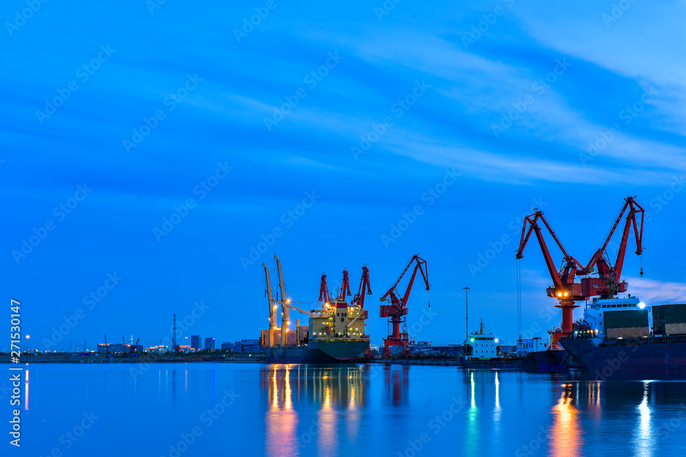 Night, cranes at harbour docks are busy working