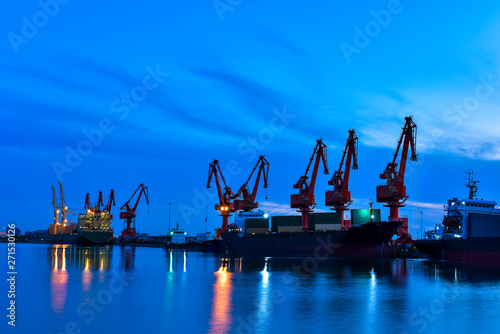 Night, cranes at harbour docks are busy working Fototapeta